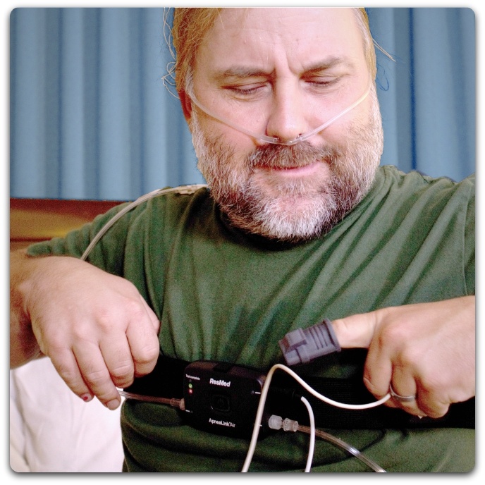Patient having a Home Sleep Test putting on chest band