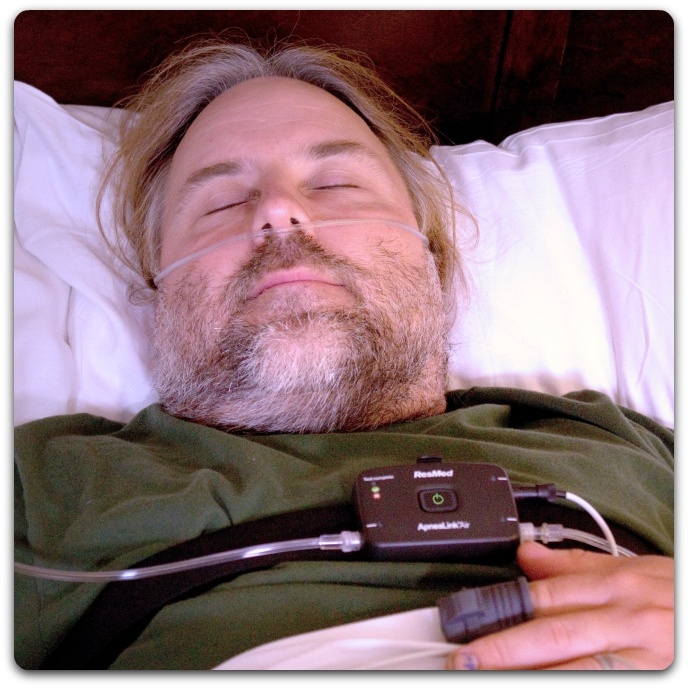 Man in bed having a Home Sleep Test
